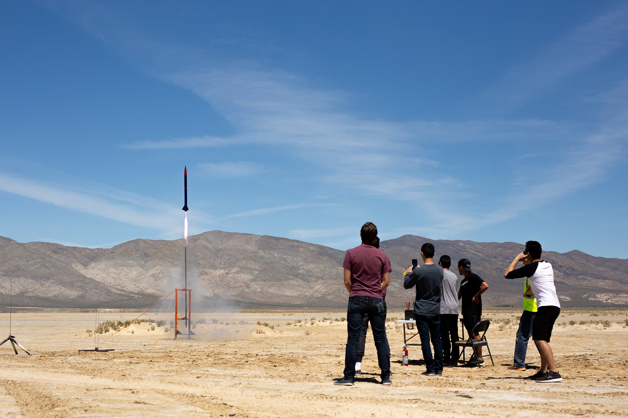 Students launching a rocket in the desert.
